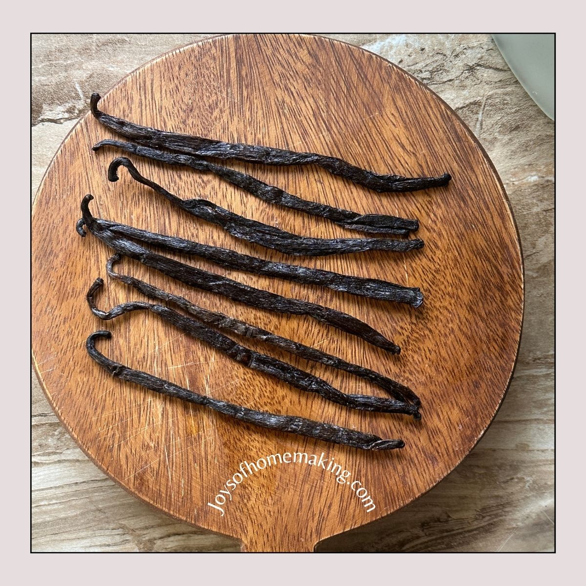 Vanilla beans on a wooden chopping board